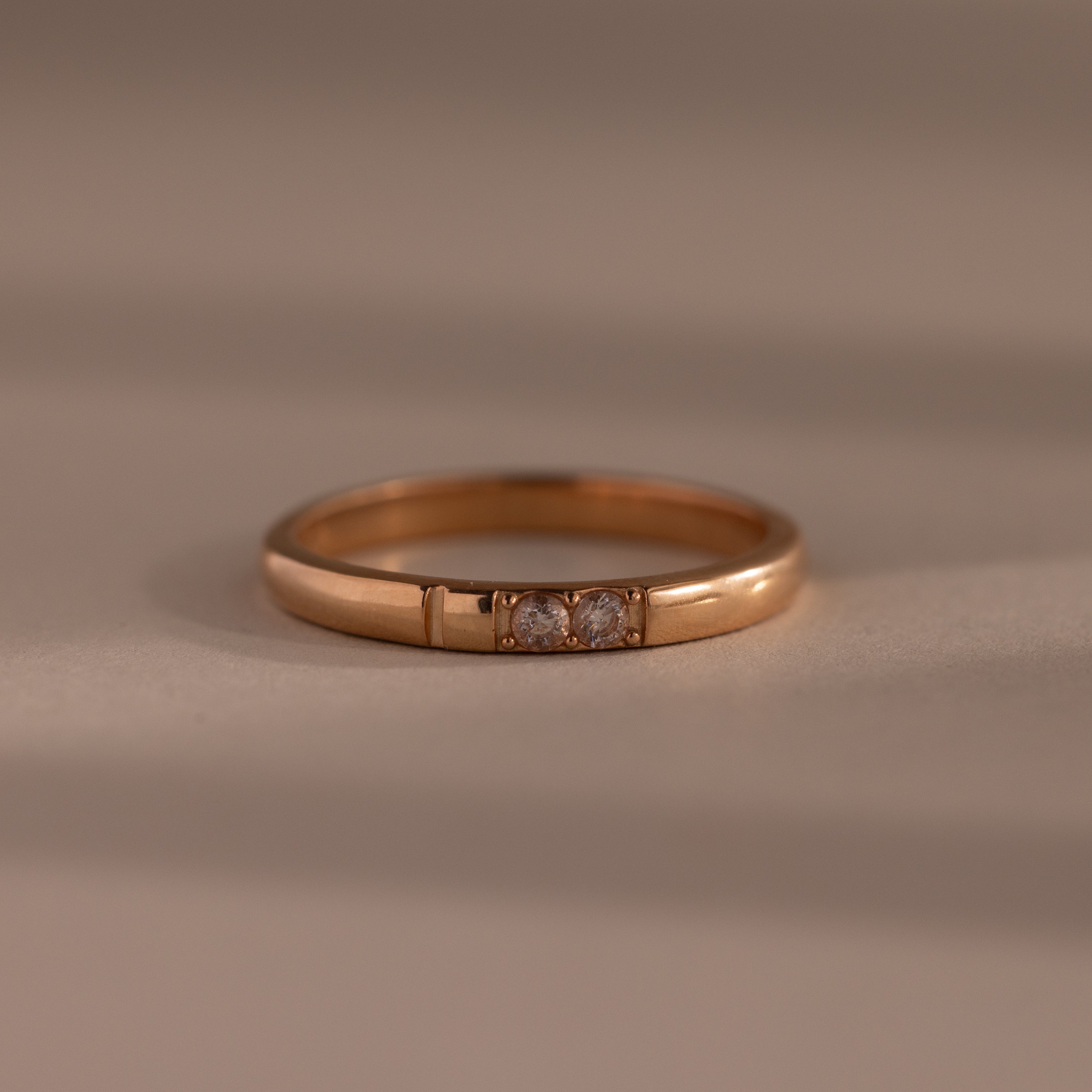 The Diamond Morse Code Ring in Rose Gold features three small center diamonds, creating an elegant and meaningful piece—perfect for those seeking a symbolic accessory.