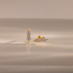 Ombre Diamond Flatback Studs with round, clear gemstones in a vertical design on a neutral surface—these elegant earrings are a perfect personalized gift for any occasion.