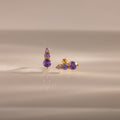Ombre Alexandrite Flatback Studs with small round purple stones, displayed on a reflective beige surface—a stylish personalized gift ideal for any occasion.
