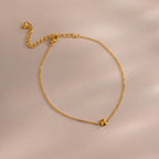 Close up of bubble initial bracelet in gold with the letter B.