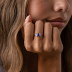 Woman resting her chin on her hand, displaying the Multiple Marquise Birthstone Ring in Sterling Silver—a striking personalized jewelry piece with three vibrant gemstones, ideal for milestone gifts.