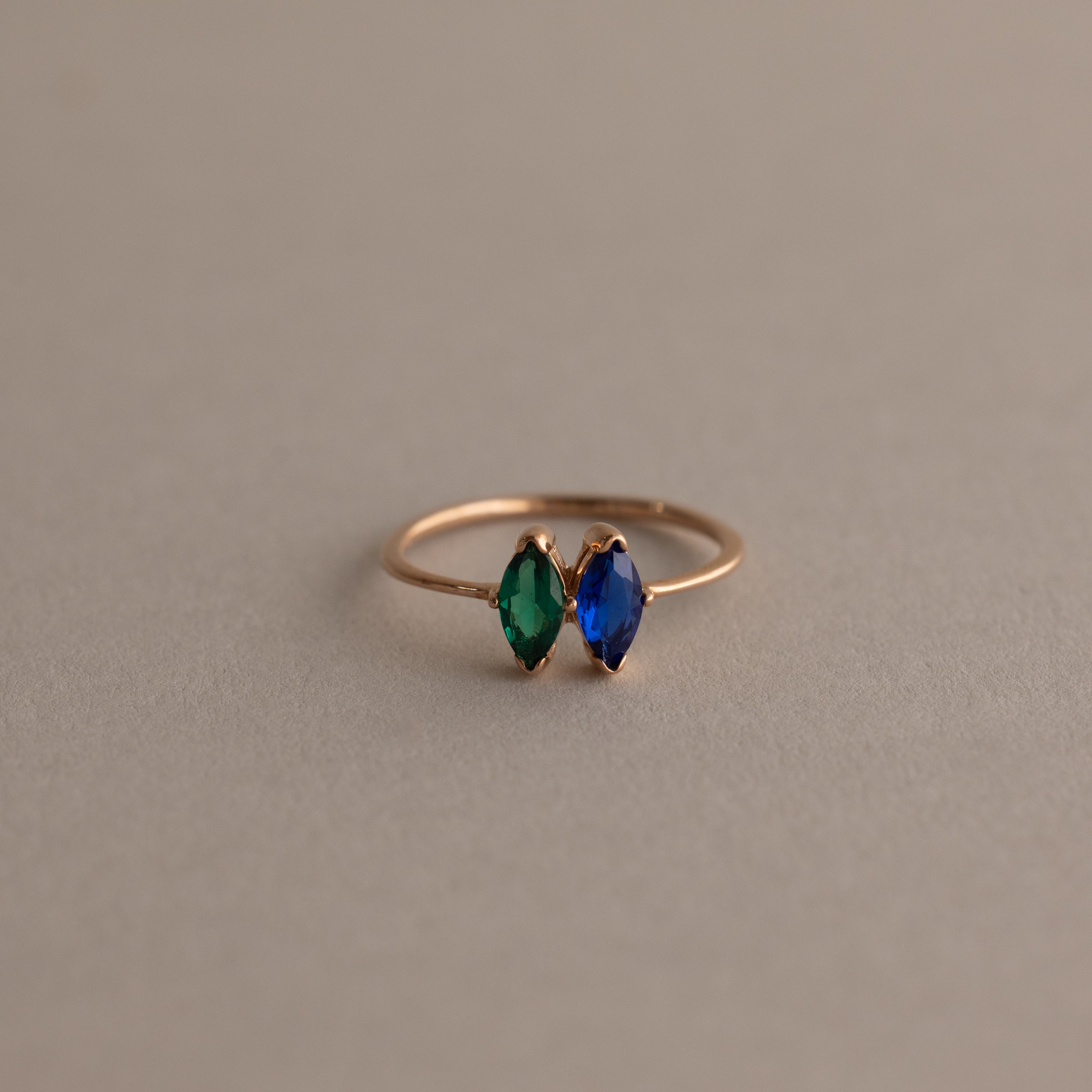 Multiple Marquise Birthstone Ring in Rose Gold with blue and green marquise-cut stones, showcased on a plain background—a stylish pick for personalized jewelry or a meaningful milestone gift.