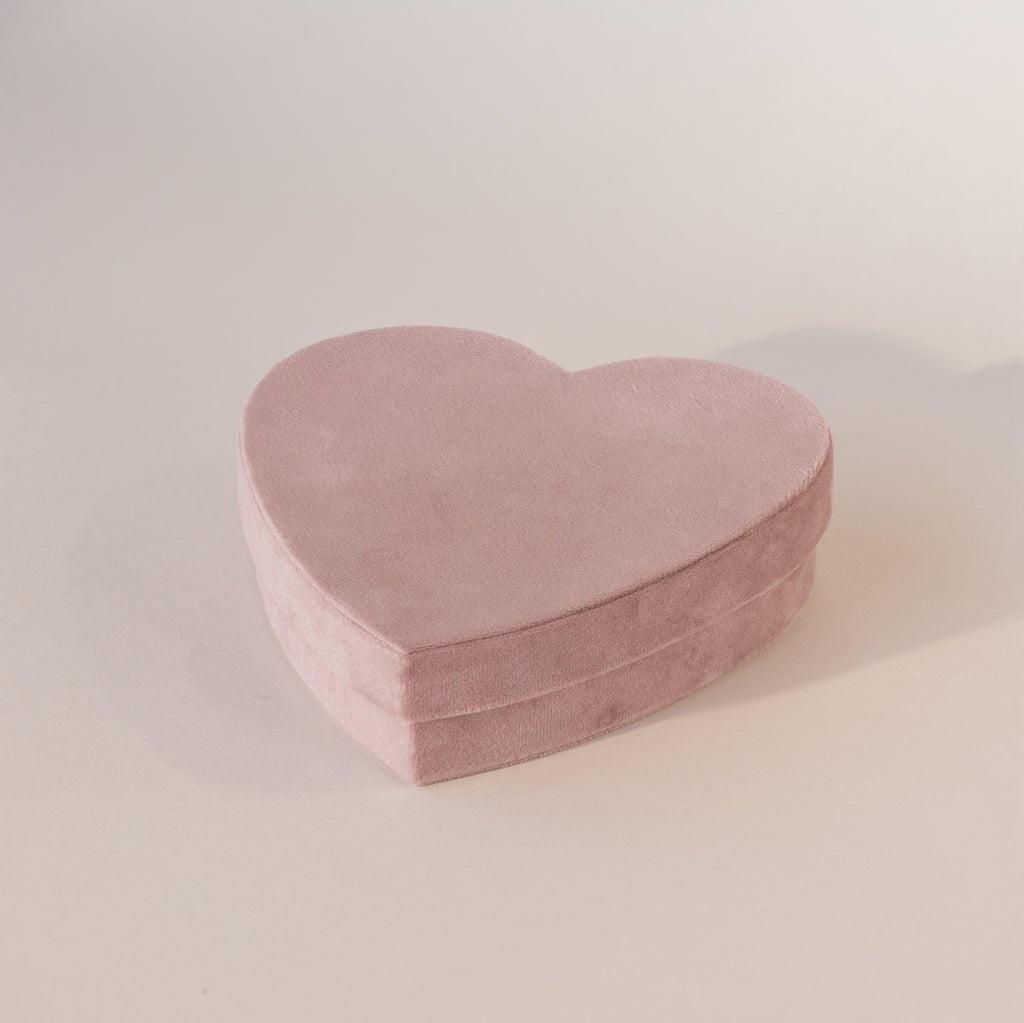 Closed lavender velvet heart-shaped jewelry box with soft matte texture, displayed against a neutral background.