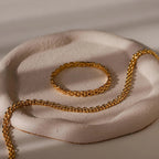 Strap Bracelet displayed on a textured, round, pale ceramic dish with soft lighting—perfect for making a bold statement.