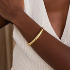Up close of model wearing gold CZ diamond north star bangle bracelet.