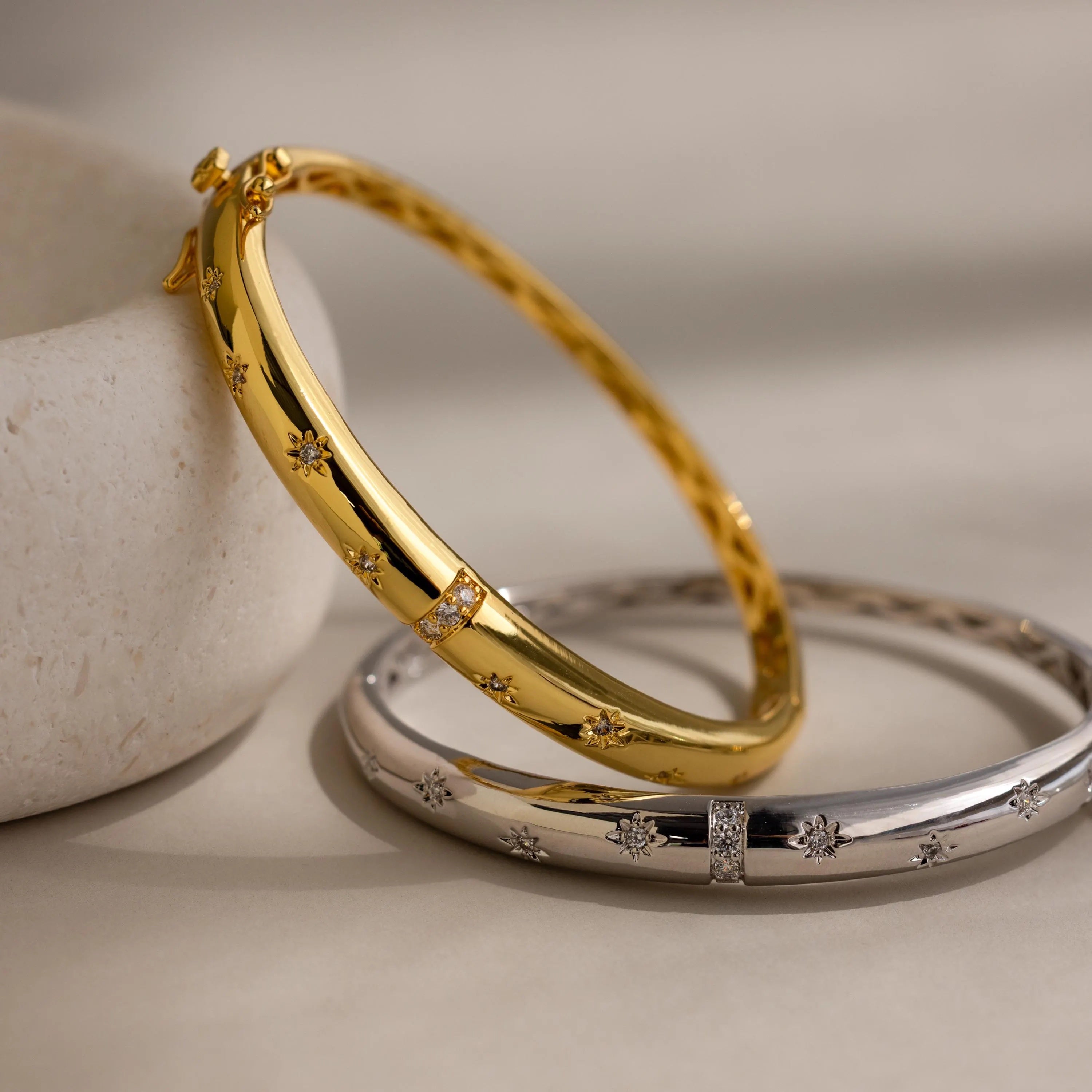 Close up of both the gold and silver North Star Diamond Bangle Bracelets.