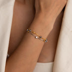 Model wearing Mixed Metal Star Bracelet with the gold chain on top.