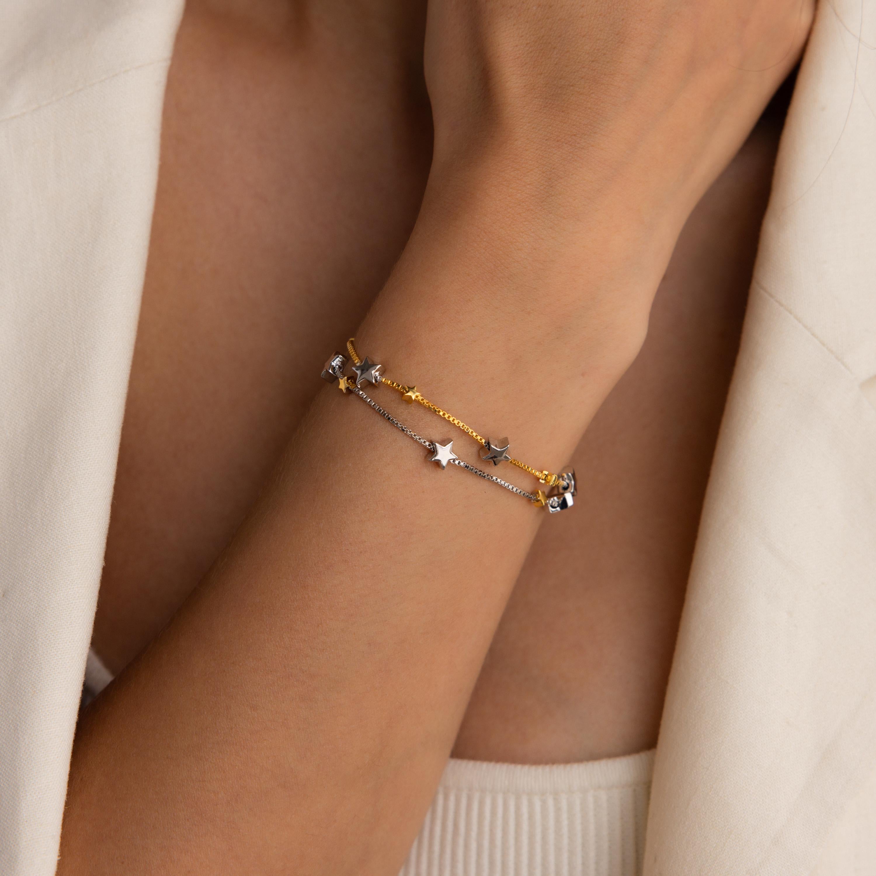 Model wearing Mixed Metal Star Bracelet with the gold chain on top.