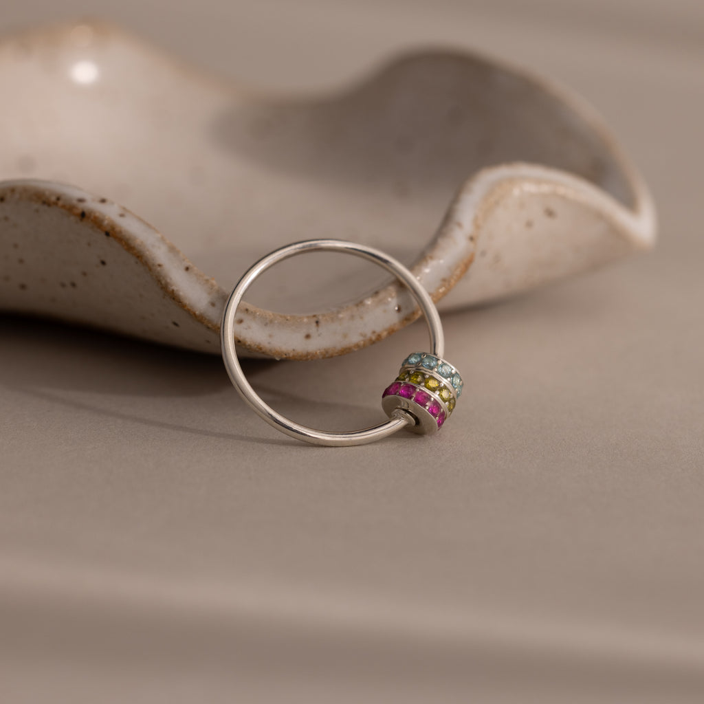 The Multiple Birthstone Bead Ring in Sterling Silver is a stylish, stackable ring featuring delicate beads—perfect for creating your own personalized jewelry look.
