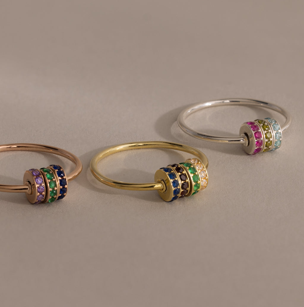 The Multiple Birthstone Bead Ring in Rose Gold features colorful gemstone-studded spinning bands, making it a unique and personalized jewelry statement or birthstone ring for any occasion.