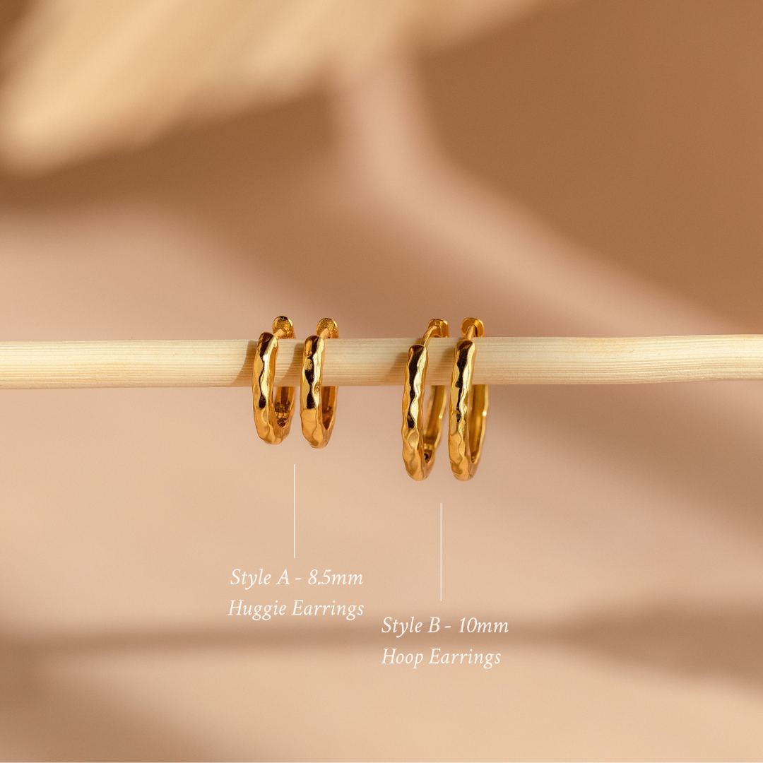 Two pairs of gold hoop earrings from the Mini Hammered Hoops Set displayed on a rod, featuring Huggie and 10mm Hammered Hoop styles.