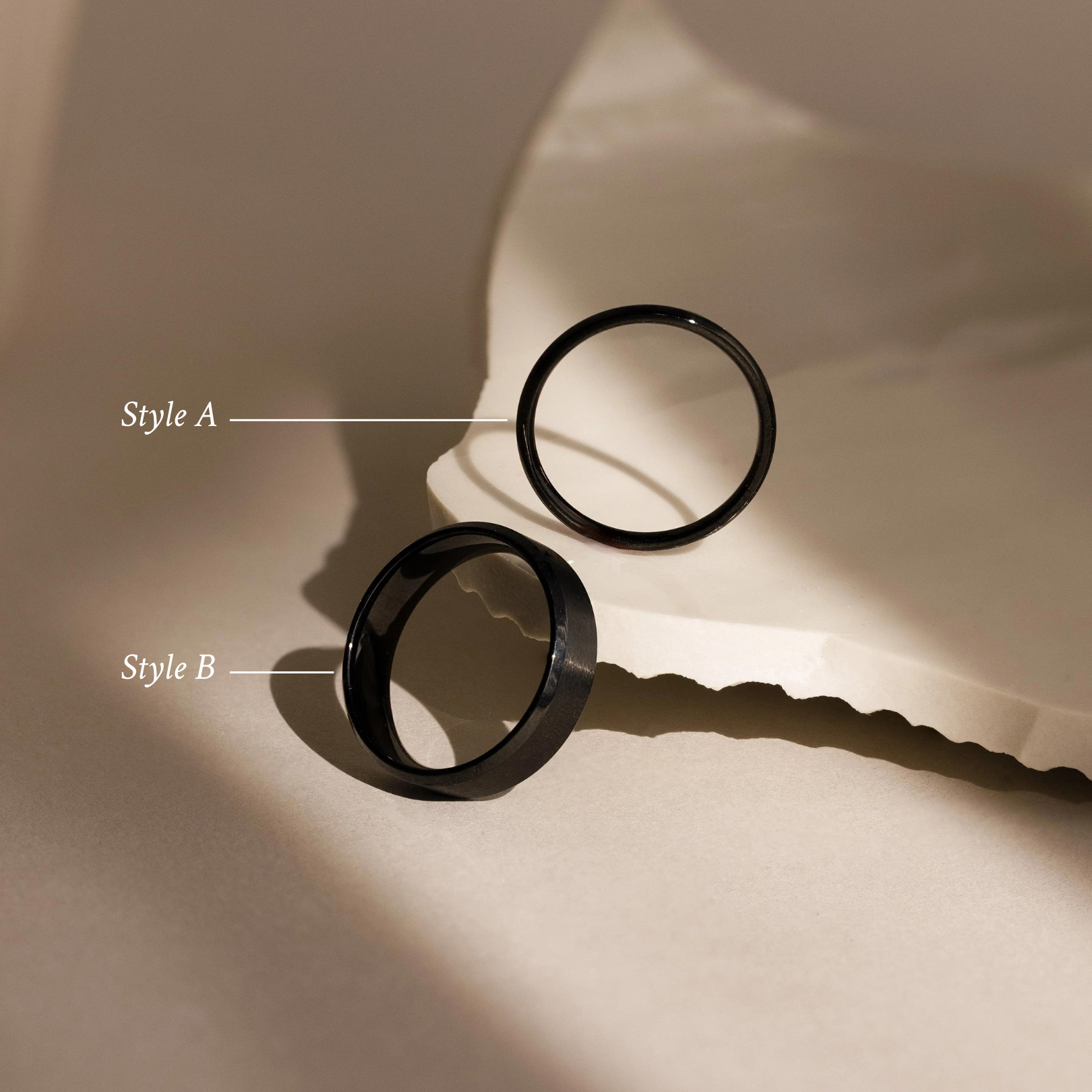 The Classic Men's Black Rings Set, featuring Style A and Style B, is displayed on a textured neutral surface—ideal for anyone seeking minimalist rings to enhance their men's jewelry collection.
