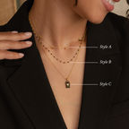 Close-up of a woman wearing the Onyx Necklace Set—three layered gold necklaces showcasing elegant, minimalist jewelry layering.