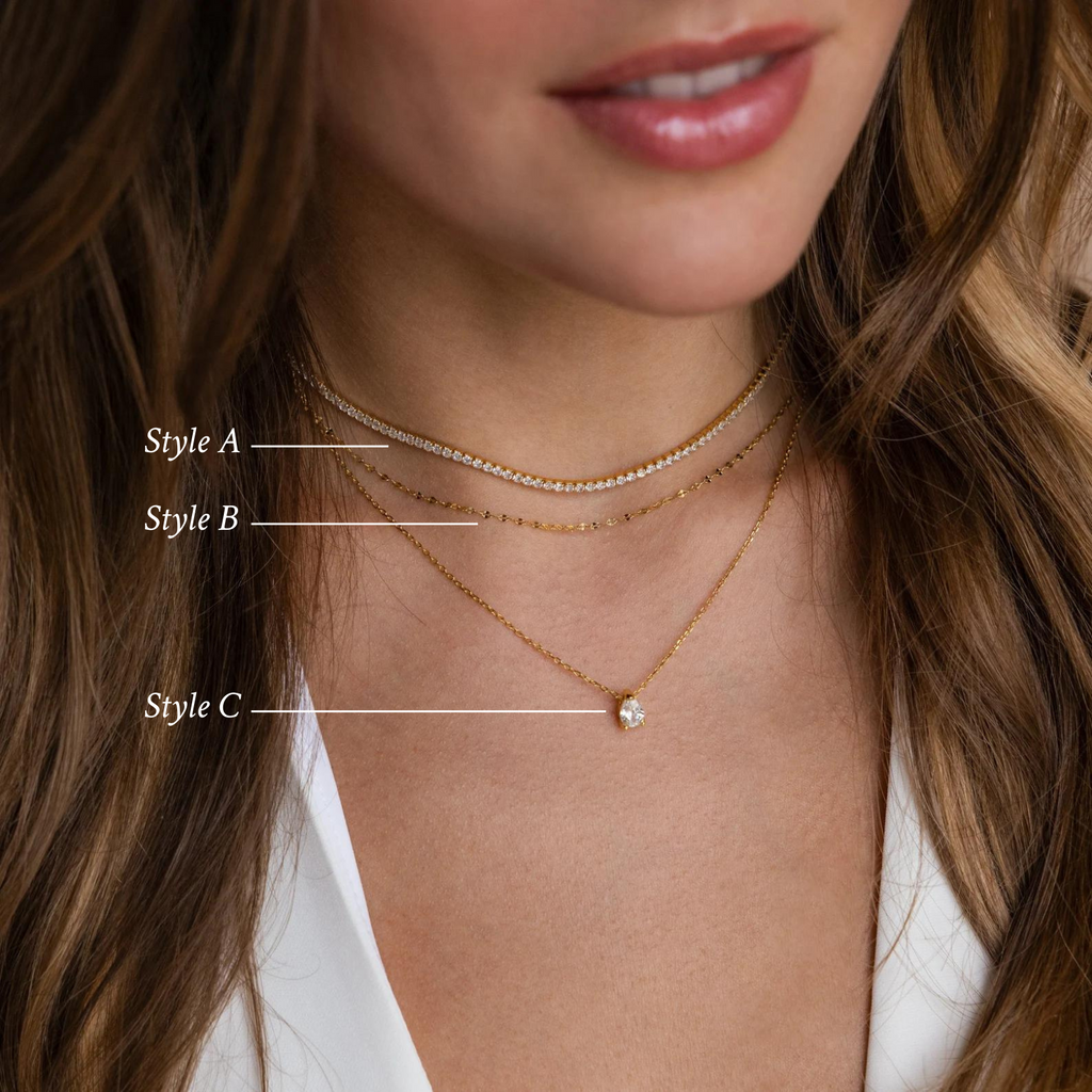Close-up of a woman wearing the Dainty Diamond Necklace Set—three layered necklaces with a shining 925 sterling silver round pendant, styled with an elegant Tennis Choker Necklace.