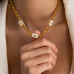 Model showcasing a gold thick curb chain necklace with 3 iridescent opal north star charms.