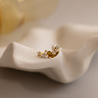 Set of 3 dainty gold round CZ Diamond Constellation Stud Earrings displayed in a ceramic dish