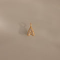 The Pave Bubble Letter Charm features diamond-studded lettering in the shape of an A, displayed on a plain beige background with a subtle shadow.