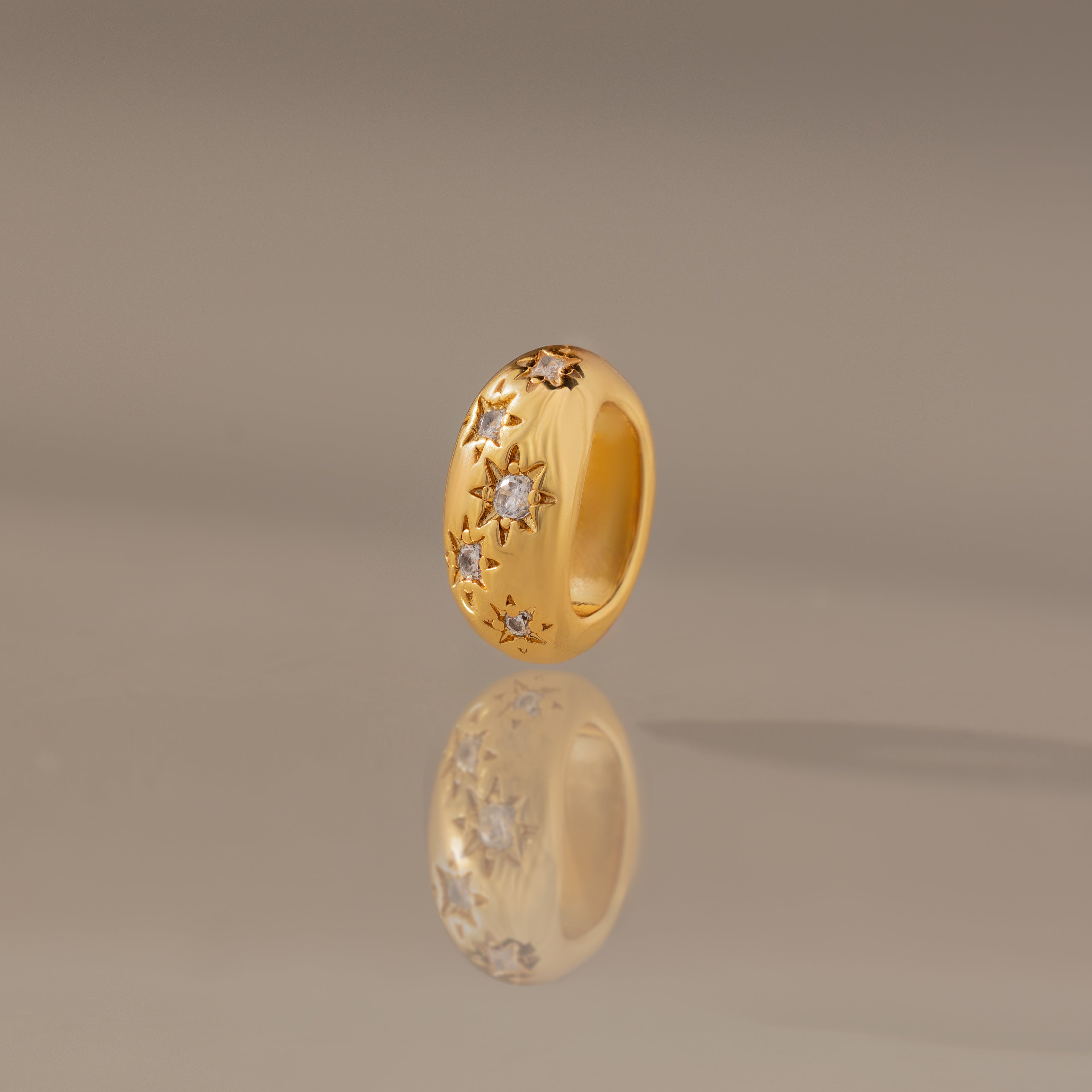The Sprinkle Diamond Dome Charm in 18K Gold features star engravings and small diamonds—ideal for your charm stack or pairing with another Dome Charm to elevate your sparkle.