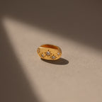The Sprinkle Diamond Dome Charm in 18K Gold features starburst-set stones and star-shaped diamond accents, beautifully illuminated on a neutral background—a stunning addition to any charm stack.