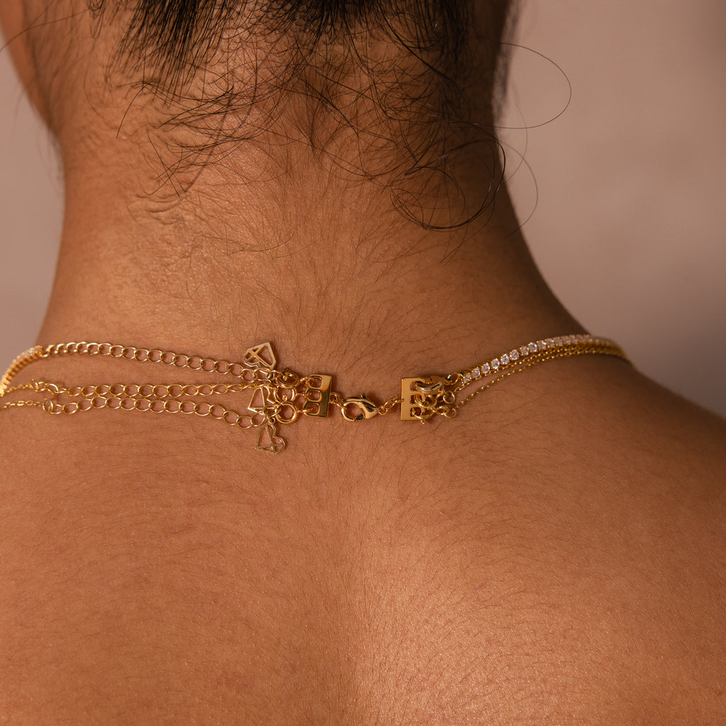 Close-up of the Triple Layering Clasp on the back of a neck, securing layered chains and heart charms for easy, tangle-free necklace stacking.