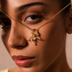 Woman holding a Pave Bubble Letter Charm necklace close to her face, accentuating her eye and lips.