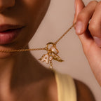 A woman delicately holds the Bold Pave Dome Charm in 18K Gold near her lips, radiating elegance and grace.
