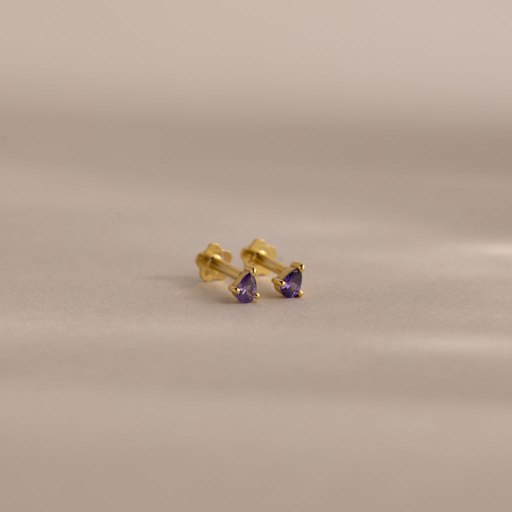 A pair of Teardrop Amethyst Flatback Studs featuring purple stones—ideal as birthstone jewelry or a thoughtful birthday gift.