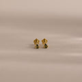 A pair of Teardrop Peridot Flatback Studs, small gold earrings with vibrant peridot stones, perfect as a jewelry gift, displayed on a neutral background.