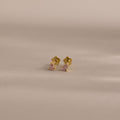 Teardrop Pink Tourmaline Flatback Studs—small gold studs with pink tourmaline gems—are perfect for a subtle touch of birthstone jewelry, displayed on a neutral background.
