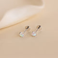 The Opal Flat Back Studs in Sterling Silver are comfortable sleeper earrings featuring round opal gemstones, displayed as silver studs on a light beige surface.