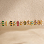 The Triple Amethyst Huggies feature three sparkling amethyst stones in elegant gold settings—ideal for minimalist jewelry lovers or anyone seeking customizable gemstone earrings.