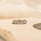 The Diamond Stacking Ring Set in Sterling Silver shines on a light beige stone surface in soft, natural light—a refined set ideal for stacking or gifting, especially as a thoughtful Christmas present.