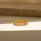 Elegant and eye-catching, the Crystal Stacking Ring Set features shimmering crystal gemstones on gold bands, beautifully displayed on a white surface under soft natural light.