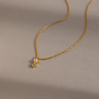 The Pearl Diamond Drop Necklace features a small pearl and clear gemstone pendant—an elegant choice for bridal jewelry.