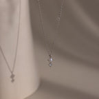 The Pearl Diamond Drop Necklace features a small pearl and diamond pendant, making it an elegant bridal jewelry choice.