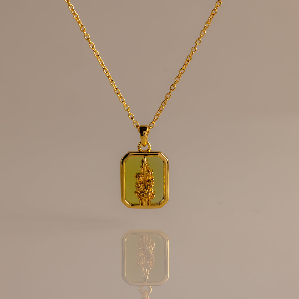 Peridot Birth Flower Charm Necklace with a rectangular pendant and raised floral design, ideal for elegant jewelry lovers and gift ideas, shown on a neutral background.