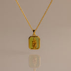 Peridot Birth Flower Charm Necklace with a rectangular pendant and raised floral design, ideal for elegant jewelry lovers and gift ideas, shown on a neutral background.