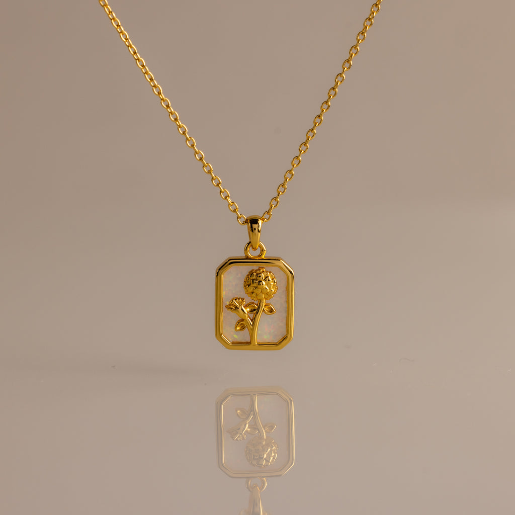 Opal Birth Flower Charm Necklace with a rectangular pendant featuring a flower design, displayed on a plain background.