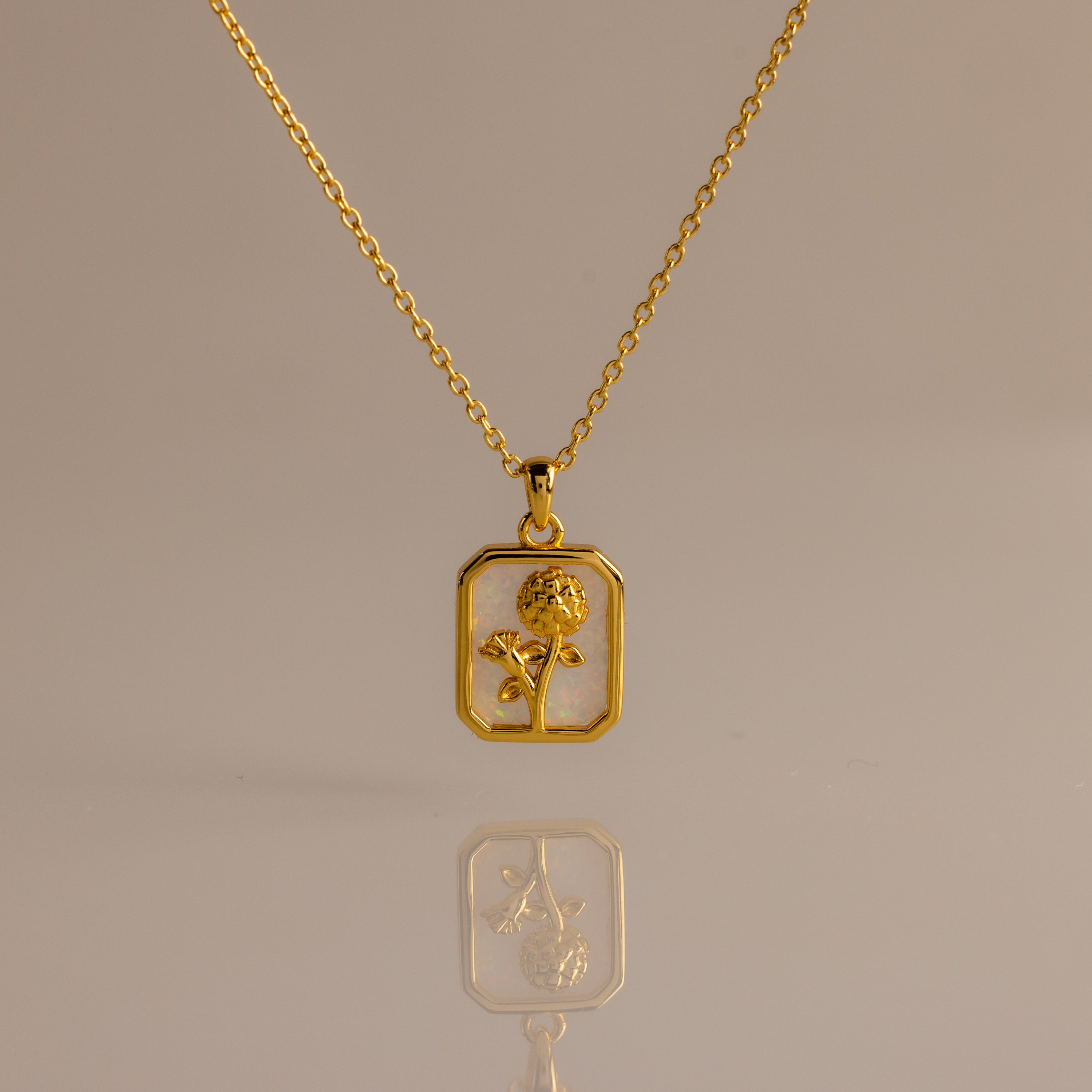 Opal Birth Flower Charm Necklace with a rectangular pendant featuring a flower design, displayed on a plain background.