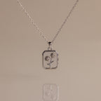Diamond Birth Flower Charm Necklace with a rectangular pendant showcasing two outlined flowers on a neutral background—ideal for adding subtle floral elegance to any outfit.