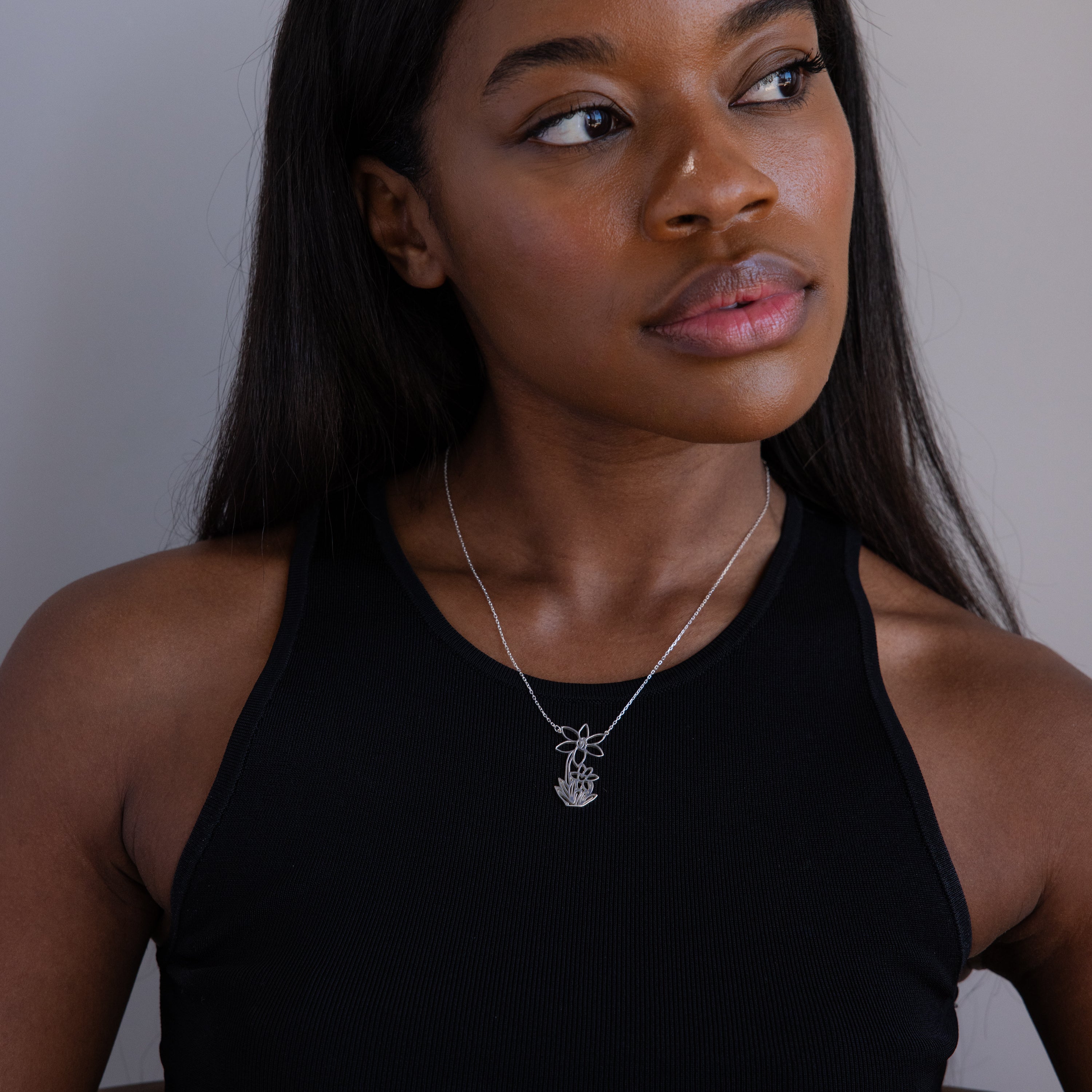 Woman in a black sleeveless top wears a silver Kids Drawing Necklace, looking slightly to the side—an elegant pose transformed into wearable art and making for a unique personalized gift.