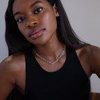 Woman with long hair wears a black tank top and the Paperclip Toggle Necklace in Sterling Silver, looking at the camera.