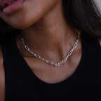 A woman shown from neck to shoulders wears a black tank top and the Paperclip Toggle Necklace in Sterling Silver.