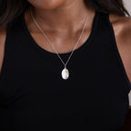A woman wears a black tank top and a Custom Fingerprint Necklace in Sterling Silver, highlighting the personalized pendant.