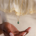 Gold satellite chain necklace featuring a single green jade teardrop gemstone pendant.