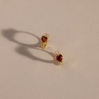 Two Garnet Heart Hoops with a red heart in the middle and diamond stones on the side 