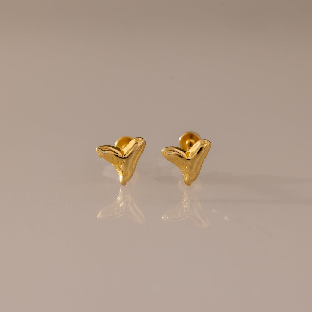 Shark Tooth Flatback Studs in gold, ideal beach accessory, shown on a neutral surface.
