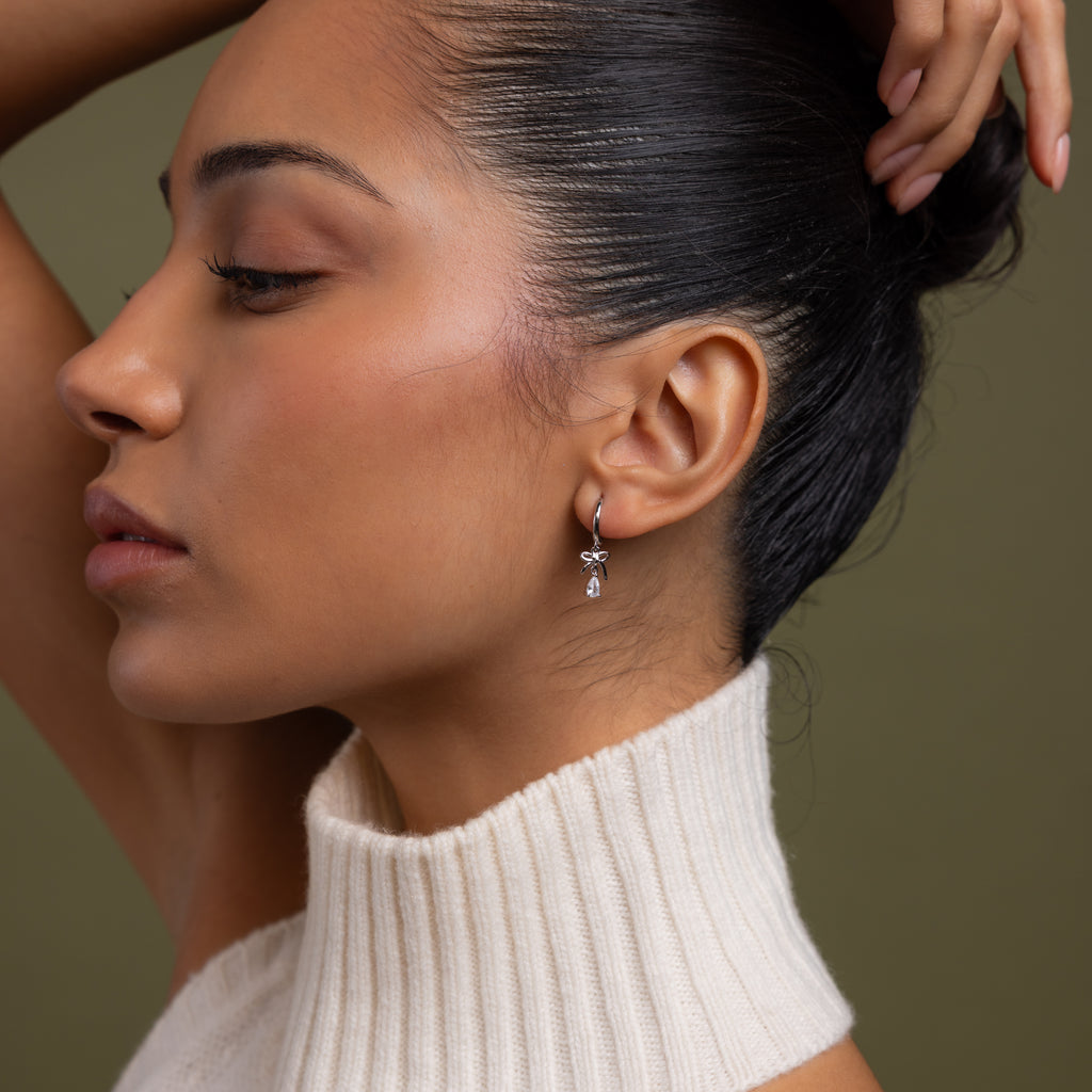 Model wearing our Teardrop Ribbon Charm Hoops in Silver