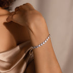 A graceful wrist shot of the Ribbed Heart Link Bracelet in White Gold.