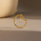 Opal Drop Chain Ring featuring a gold hoop with a small chain and a rectangular, emerald-cut opal pendant, displayed on a neutral background.